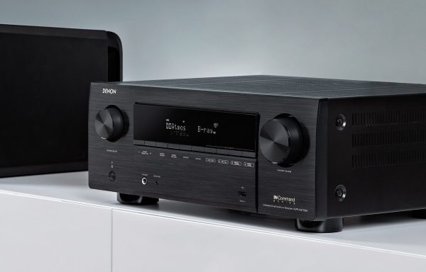 Lifestyle image of Denon AVC-X3700H angled away and to the left on AV cabinent.