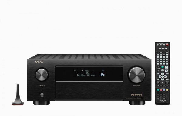 Front view of Denon AVC-X4700H AV Receiver with remote control and audssey microphone with front panel closed.