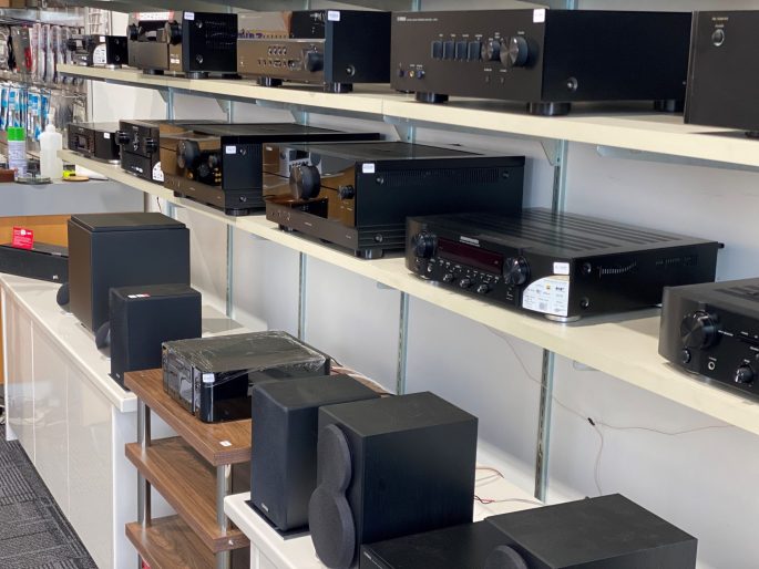 Image of the shelfs in store showing products from Marantz, Yamaha and Polk Audio