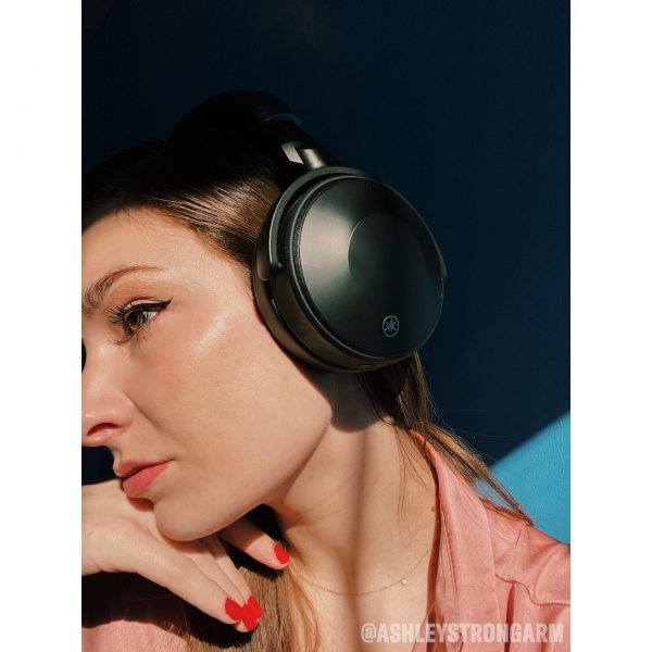 Lifestyle image of Yamaha YH-E700A Wireless Noise Cancelling Headphones on female model .