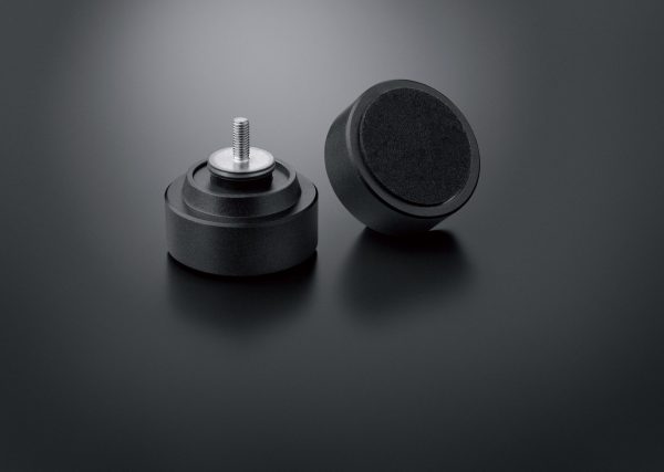 Two feet from Technics SL1210GR sitting on black background.